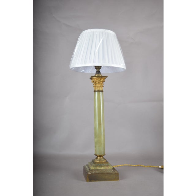 Neoclassical column table lamp dating to the 1930s. The natural green onyx column is topped by a Corinthian capital in...