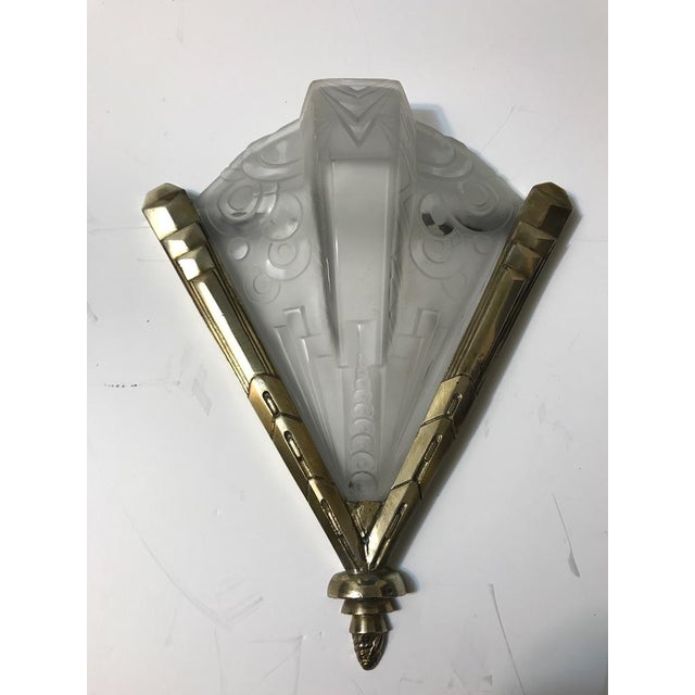 Stunning pair of French Art Deco geometric sconces signed by Muller Freres Luneville. Having clear frosted glass with over...
