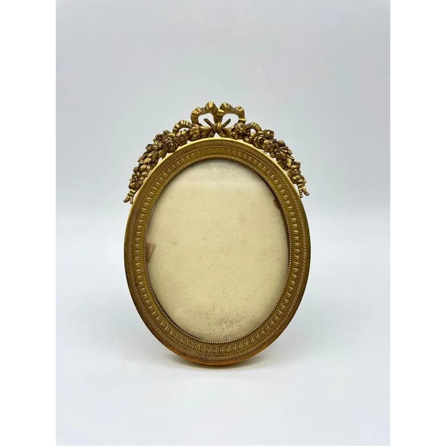 Neoclassical picture frame made of solid bronze with extremely fine engraving and gilding. Oval body with neoclassical...
