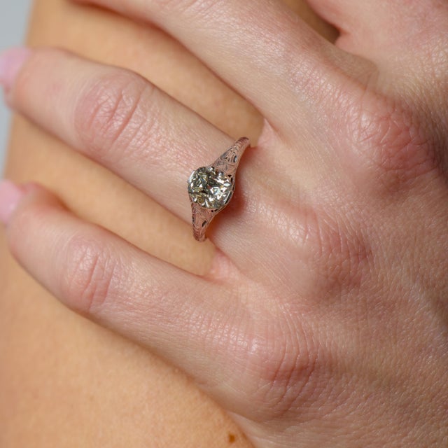 This refined Art Deco engagement ring is a beautiful representation of 1930s elegance, showcasing the enduring allure of...