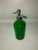 A green glass seltzer bottle with chrome dispenser top. Circa 1900 purchased tin France.