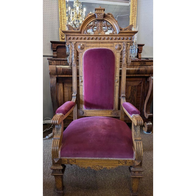 Monumental oak gothic throne chair, wine velvet upholstery. Highly carved and in excellent condition for over 100 years of...