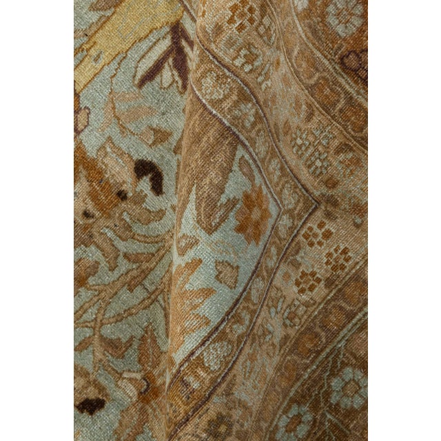 Tabriz is one of the oldest and most renowned weaving centers in the world. This antique Persian rug, made circa 1930, is...