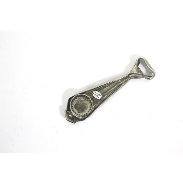 This is a vintage, silver plated bottle opener in the shape of a tie. Essential barware for any bar cart. This is in great...