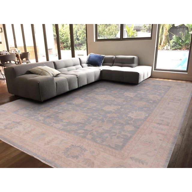 Enhance the ambiance of your home with this magnificent Persian-influenced Turkish hand-knotted rug made by skilled...