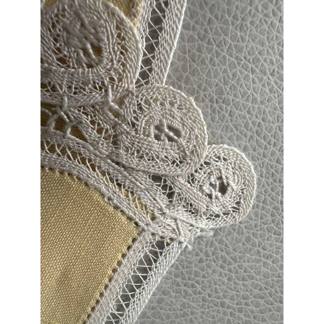 "A luminous pair of vintage linen guest towels in a soft canary yellow, a color chosen not for necessity but for beauty,...