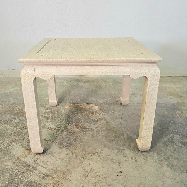 This vintage side table by Lane whispers of quiet refinement, its cream enamel finish touched with delicate crackle....