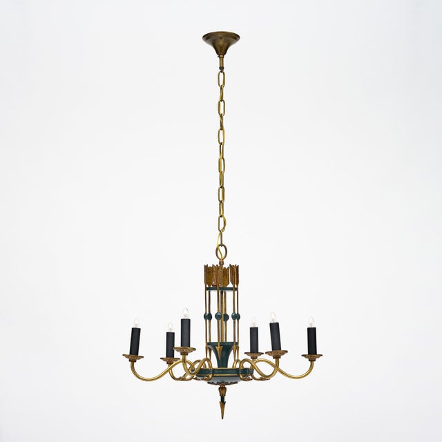 Chandelier from France featuring a bronze structure and six candelabra arms. The chandelier is adorned with an arrow motif...
