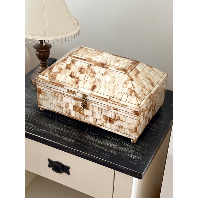 This large-scale Hollywood Regency style tessellated horn and bone inlay vanity chest is a stunning statement piece....