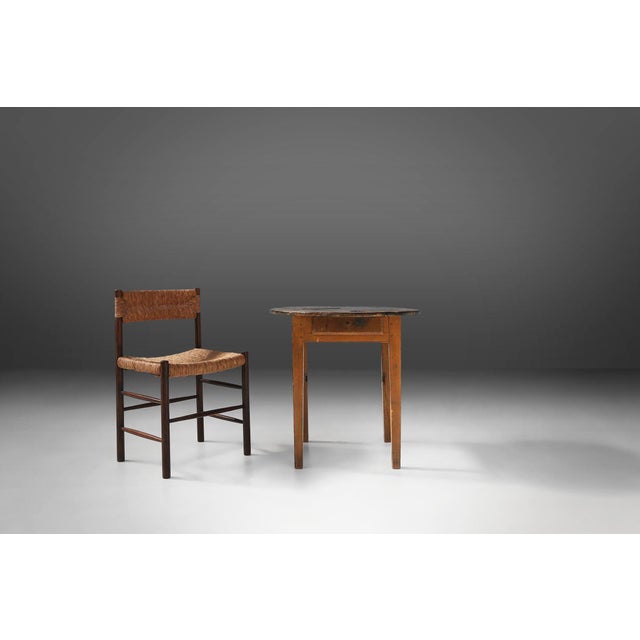 A characterful 19th‑century French side table, crafted around 1850 in solid oak and embodying the honest simplicity of...