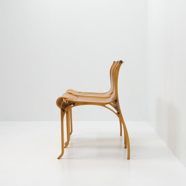 Model a chair produced by cristian valdés in his own workshop during the late 1970s. the chair features a laminated wood...