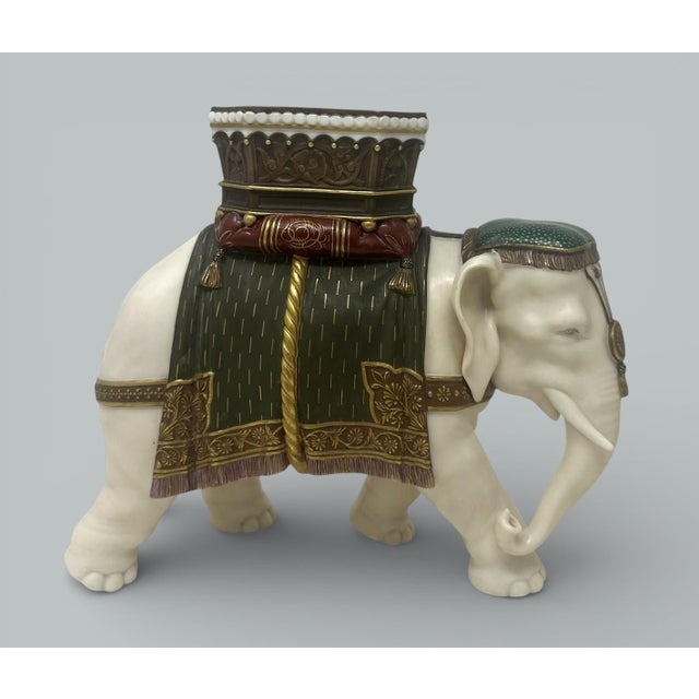 An exceptionally well cast English Porcelain Flower Vase modelled as an Indian Elephant, decorated in colours with elegant...
