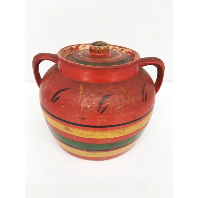 The 1930's Multicolor 2 Handle Covered Pottery Pot Jar is a timeless and charming piece of vintage pottery that exudes the...