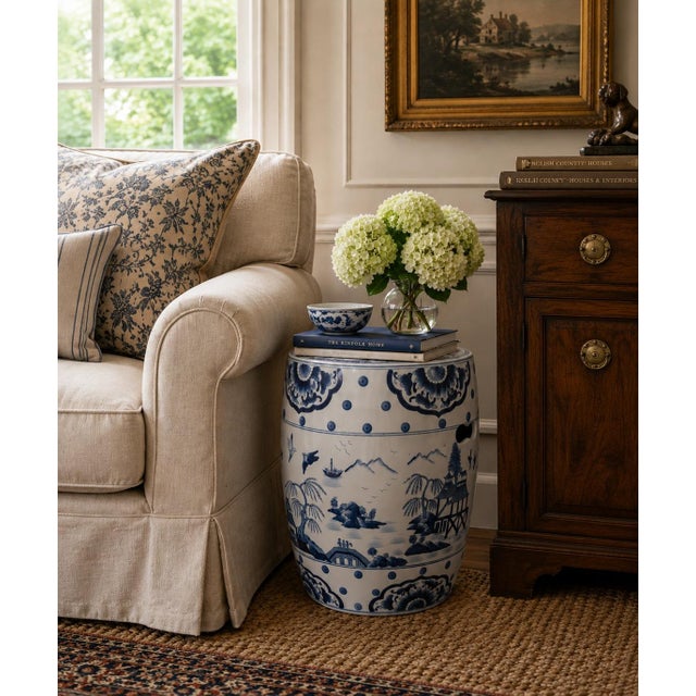 A classic blue and white porcelain garden stool, decorated with traditional Chinese scenes and motifs and stylized floral...