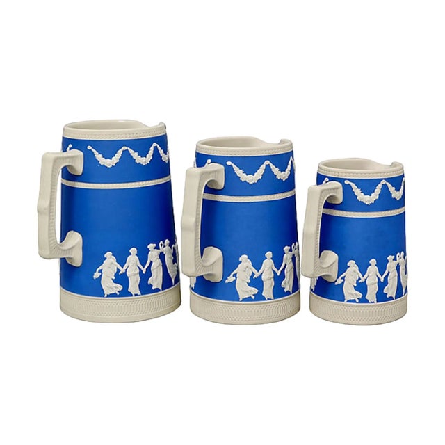 Set of three antique Copeland Spode jugs in the "Dancing Hour" pattern, circa 1890. Maker's mark on undersides. Large,...