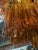 Striking Italian chandelier composed of cascading tiers of textured amber Murano glass “tronchi” elements. The sculptural...