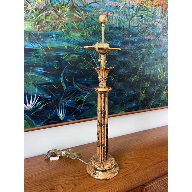A classic Frederick Cooper table lamp featuring a fluted column form with a lotus-style capital and stepped circular base....