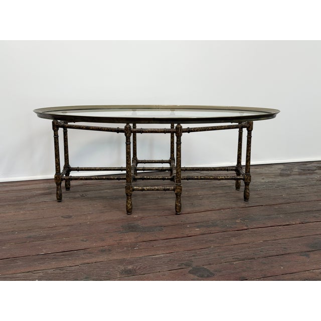 Stylish faux bamboo tortoise shell painted wood frame with removable oval brass frame glass top surface. Circa 1970-75....