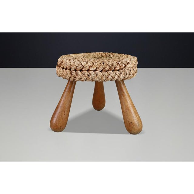 Authentic Audoux Minet French rope stool from the 1960s, featuring a handwoven seat and sculptural tripod wooden base. A...