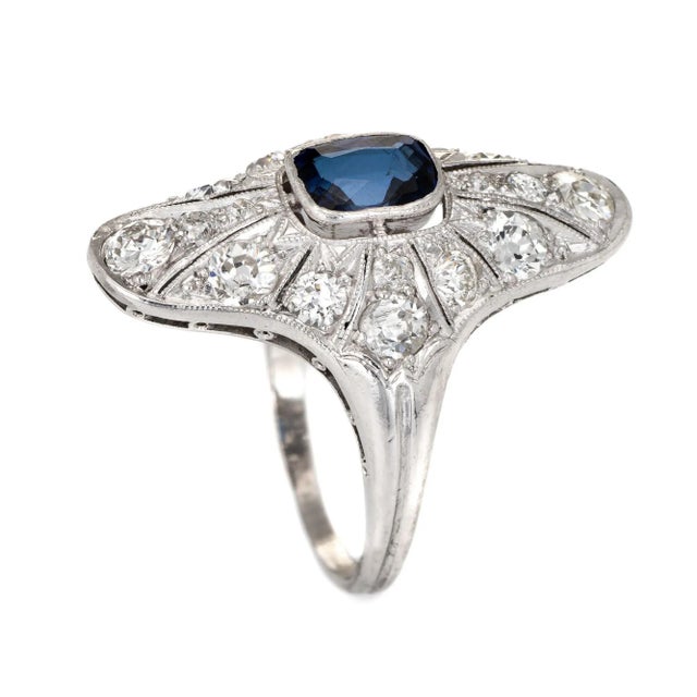 Finely detailed antique Edwardian era ring (circa 1910s) crafted in 900 platinum. Centrally mounted estimated 0.50 carat...