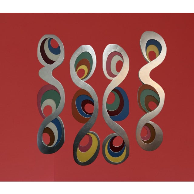 This striking wall sculpture is a vibrant example of Italian postmodern design, echoing the bold spirit of the Memphis...
