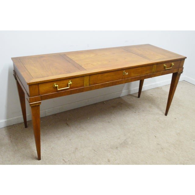 Writing Desk by Baker. Store item #529. It features three dovetailed drawers and solid wood construction .
