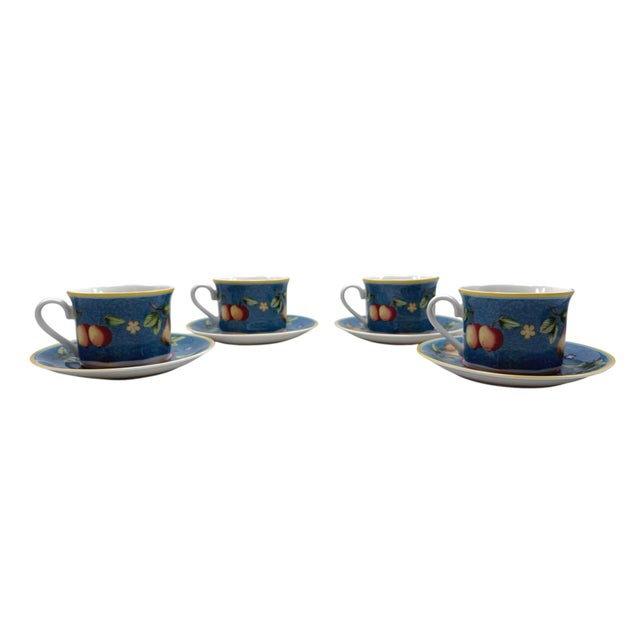 Elegant porcelain tea set featuring a vibrant blue fruit motif. Ideal for casual or formal tea settings. • Set includes 4...