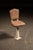 Cast iron and steel pedestal chair with a tapered, flared porcelain base, retaining its brown upholstered seat and back...