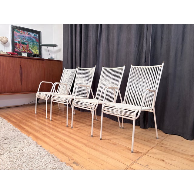 A set of four Mauser (spaghetti) chairs from the 1960s. In good original condition. The plastic on the armrests is...