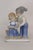 This charming Decorative Figurine is made of porcelain. Due to the style and design, we believe this was made by Lego...