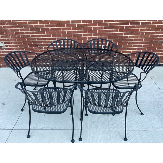 Unmarked Set of 6 wrought iron and metal mesh garden, patio, poolside dining chairs and a 54" Oval Table. The chairs have...