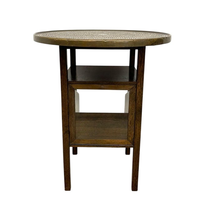 This vintage Arts & Crafts-influenced side table features a combination of wood construction and a decorative brass tray...