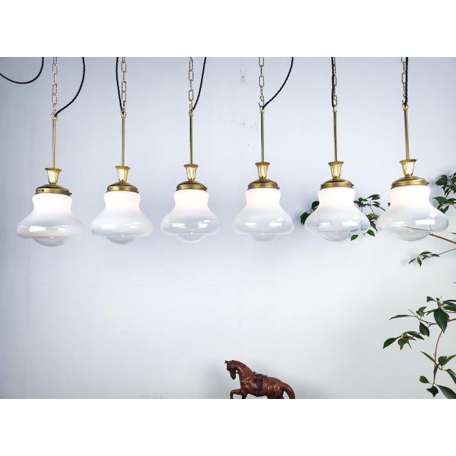 : Beautiful Italian pendant. Constructed out of brass with beautiful opaline turning clear glasses. This piece is designed...