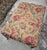 Beautiful tapestry fabric covered ottoman with brass casters on turned wooden legs. Please see condition details noted....