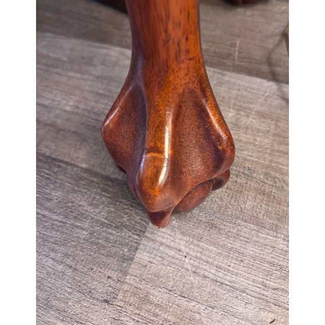 Elegant vintage mahogany oval console or sofa table featuring a richly toned oval top with contrasting satinwood-style...