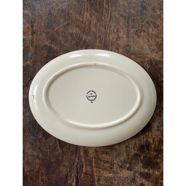 Great mid century modern vibes with this oval platter by Metlox. This California designed and made piece is presented on a...