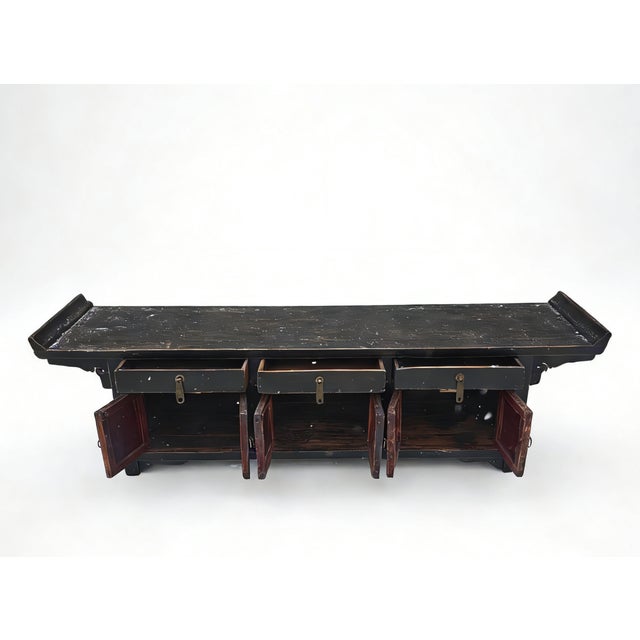 This early 19th century low altar sideboard is handmade from sturdy elm. The piece features a traditional silhouette with...