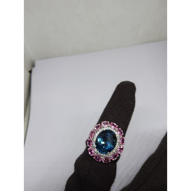 Gemstone details Gold Purity: 14K Solid Gold Blue topaz: 5.85 cts Diamond: 0.20 cts Pink sapphire: 3.25 cts 14K gold Net...