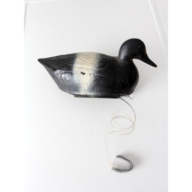 This vintage 1950s Neumann & Bennetts Plasti-Duk hunting decoy is modeled as a drake scaup, or bluebill, with a molded...