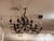 Design Plus Gallery presents a Twig Chandelier from Paul Ferrante. Model No. 2081 displays an intricate iron framework of...