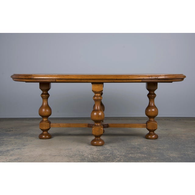 An elegant early 20th-century French Provincial dining table, sourced from Provence, France. Beautifully handcrafted from...