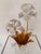 Elegant contemporary floral sculpture featuring delicate porcelain blossoms accented by rich gold leaf metal stems and...
