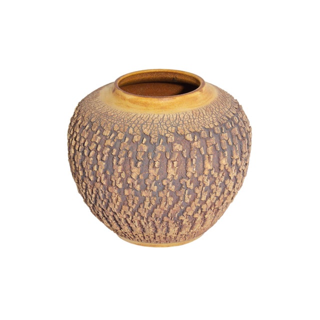 A studio pottery vase by the American ceramicist Barry Vantiger. This rounded vase features a brown, textured exterior,...