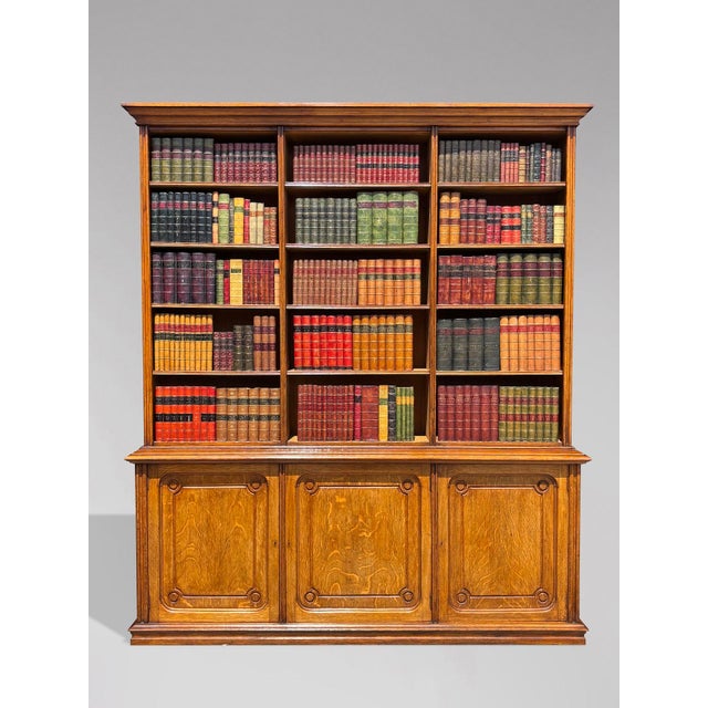 A striking and highly practical mid 19th-century French tall open library bookcase in solid oak, of exceptional depth and...