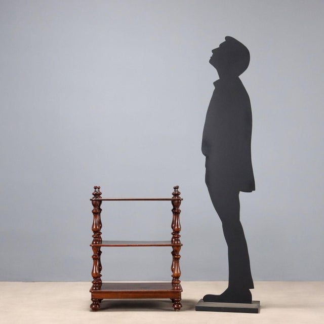 Mid-19th century walnut étagère featuring an elegant three-shelf structure. Each shelf is supported by four finely turned...