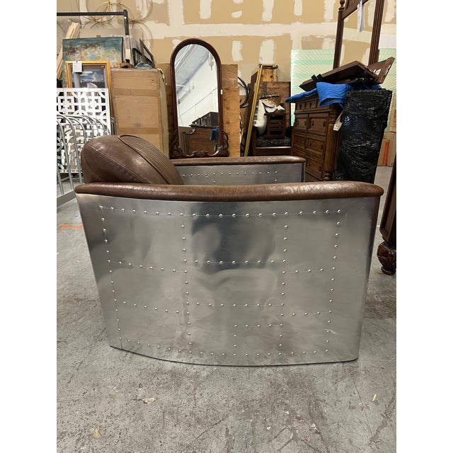 The New Pacific Direct Brown Leather & Aluminum “Easton” Aviator Lounge Chair combines bold industrial design with...