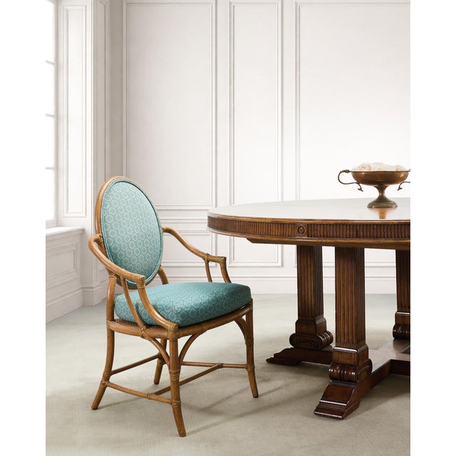 A luxurious set of ten upholstered dining armchairs crafted out of rattan and cane by artisans at McGuire Furniture, San...