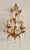 A highly decorative, hand-forged wall sconce, gilded in gold leaf with floral and leaf embellishments and crystal drops. a...