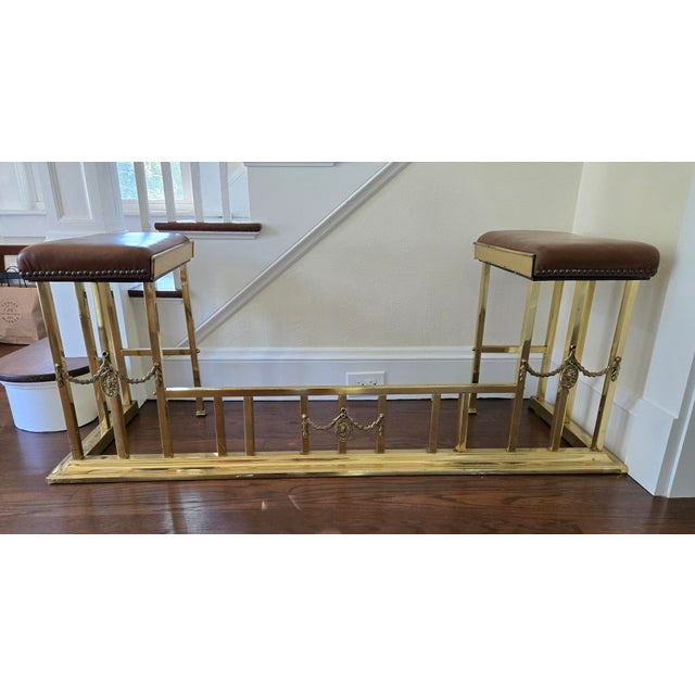 Brass Fireplace Club Fender with brown Leather Upholstered Seats featuring brass nailhead trim and and decorative...