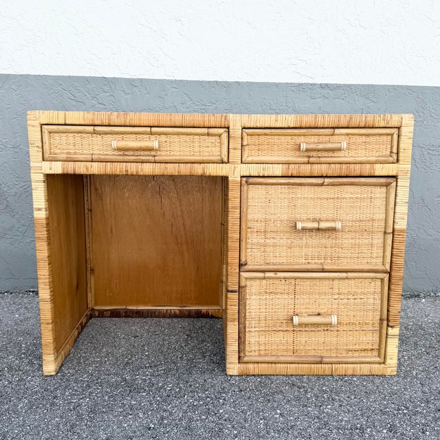 Charming vintage Boho Chic writing desk crafted with woven wicker, rattan, and bamboo details in a warm natural finish....